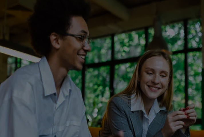 Man and woman standing in front of a window, smiling